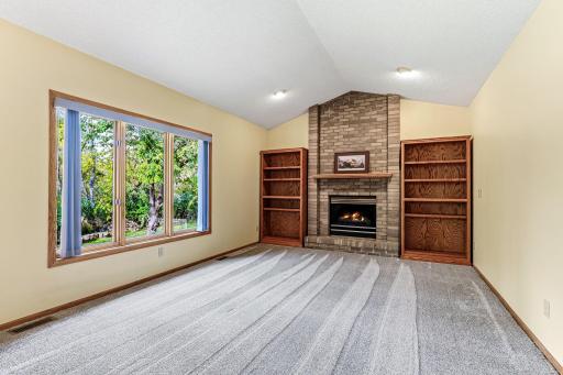 Family room featuring a large picture window framing beautiful views of the backyard.