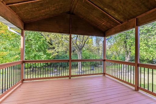 Covered deck just off the kitchen, perfect for outdoor dining and year-round enjoyment.