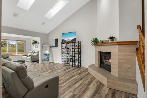 Gas fireplace with Vaulted Ceilings leads into sunroom overlooking Pond & Brackett's 10th