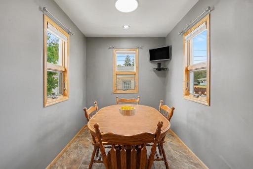 INFORMAL DINING ROOM IS SURROUNDED BY NATURAL LIGHTING AND FRESH PAINT