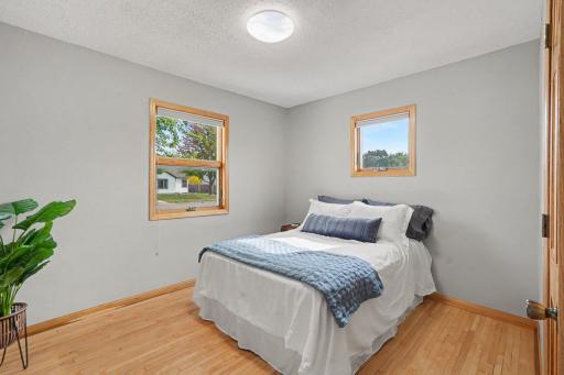 SPACIOUS MAIN LEVEL BEDROOM WITH BEAUTIFUL 'REAL' WOOD MAPLE FLOORING AND NEWER LIGHTING