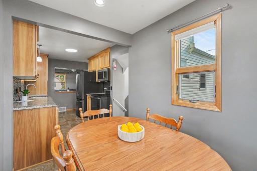 INFORMAL DINING ROOM IS ADJACENT TO THE KITCHEN AND HAS AN ABUNDANCE OF NATURAL LIGHTING AND FRESH PAINT