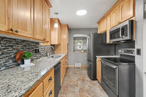 BLACK FINGERPRINT-PROOF STAINLESS STEEL APPLIANCES, UPDATED LIGHTING AND FIXTURES