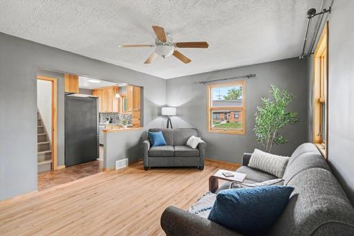 BEAUTIFUL MAPLE 'REAL WOOD' MAPLE FLOORING AND MULTIPLE WINDOWS ALLOW FOR NATURAL LIGHTING TO COME STREAMING IN