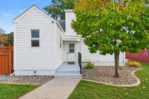 CONVENIENT BACKYARD ENTRY FROM FULLY FENCED YARD AND GARAGE