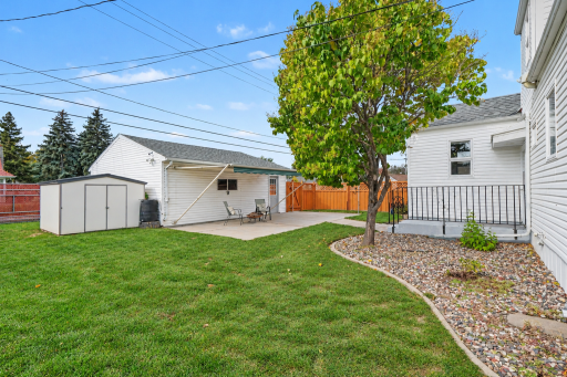 360Âº LANDSCAPING WITH CONCRETE CURBING AND PATIO WITH RETRACTABLE AWNING, STORAGE SHED AND DOUBLE GATED ACCESS TO THE BACKYARD.