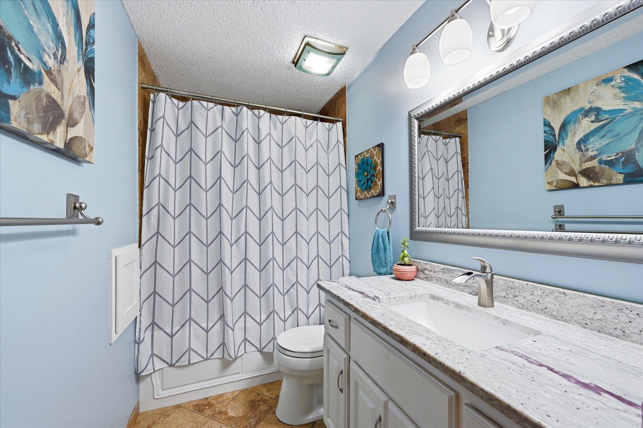 Full upper level bathroom updated as part of the 2016 remodel, offering a refreshed and functional space.