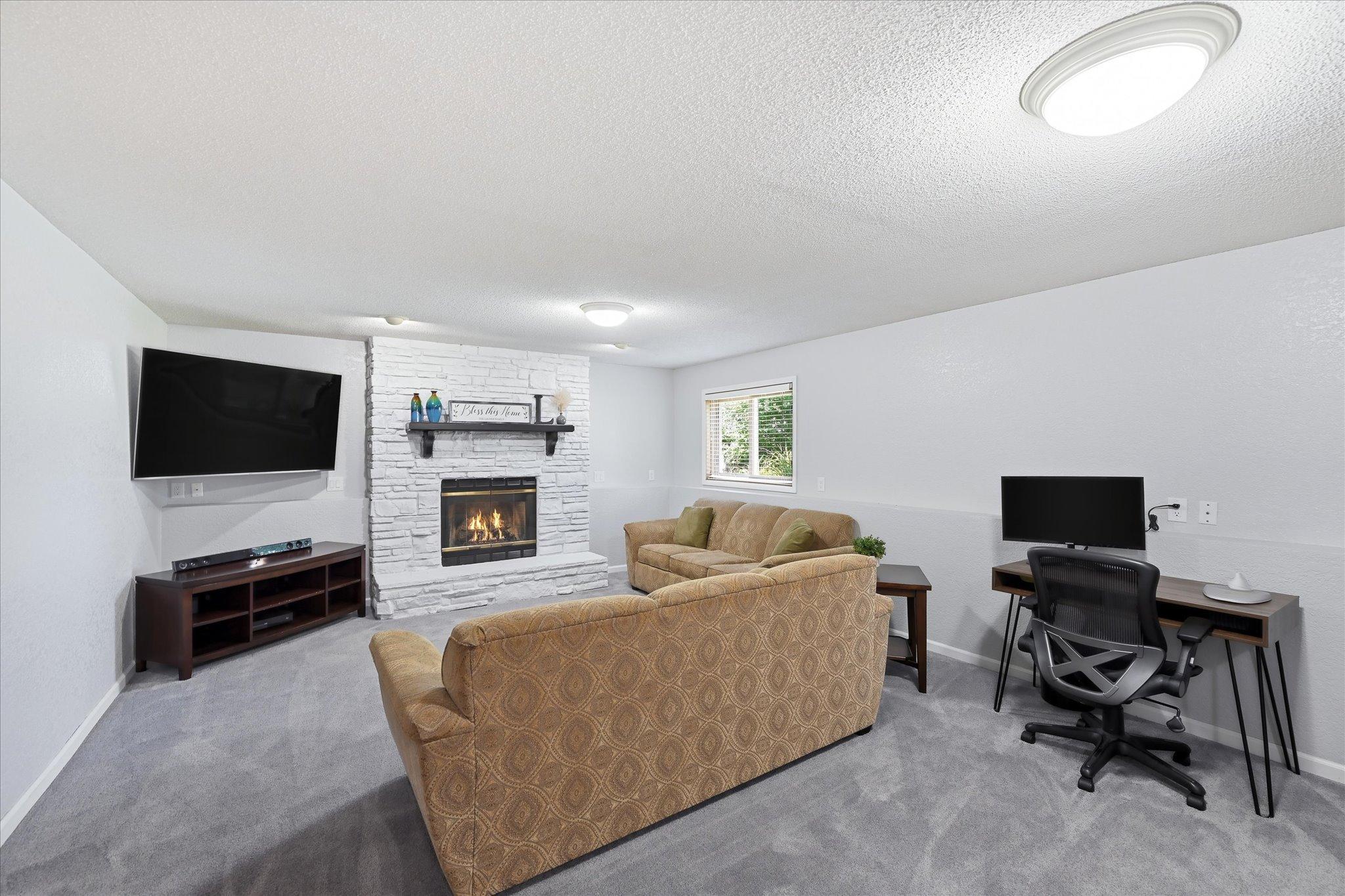 The lower level family room perfect spot for movie nights, game days or simply relaxing by the fireplace.