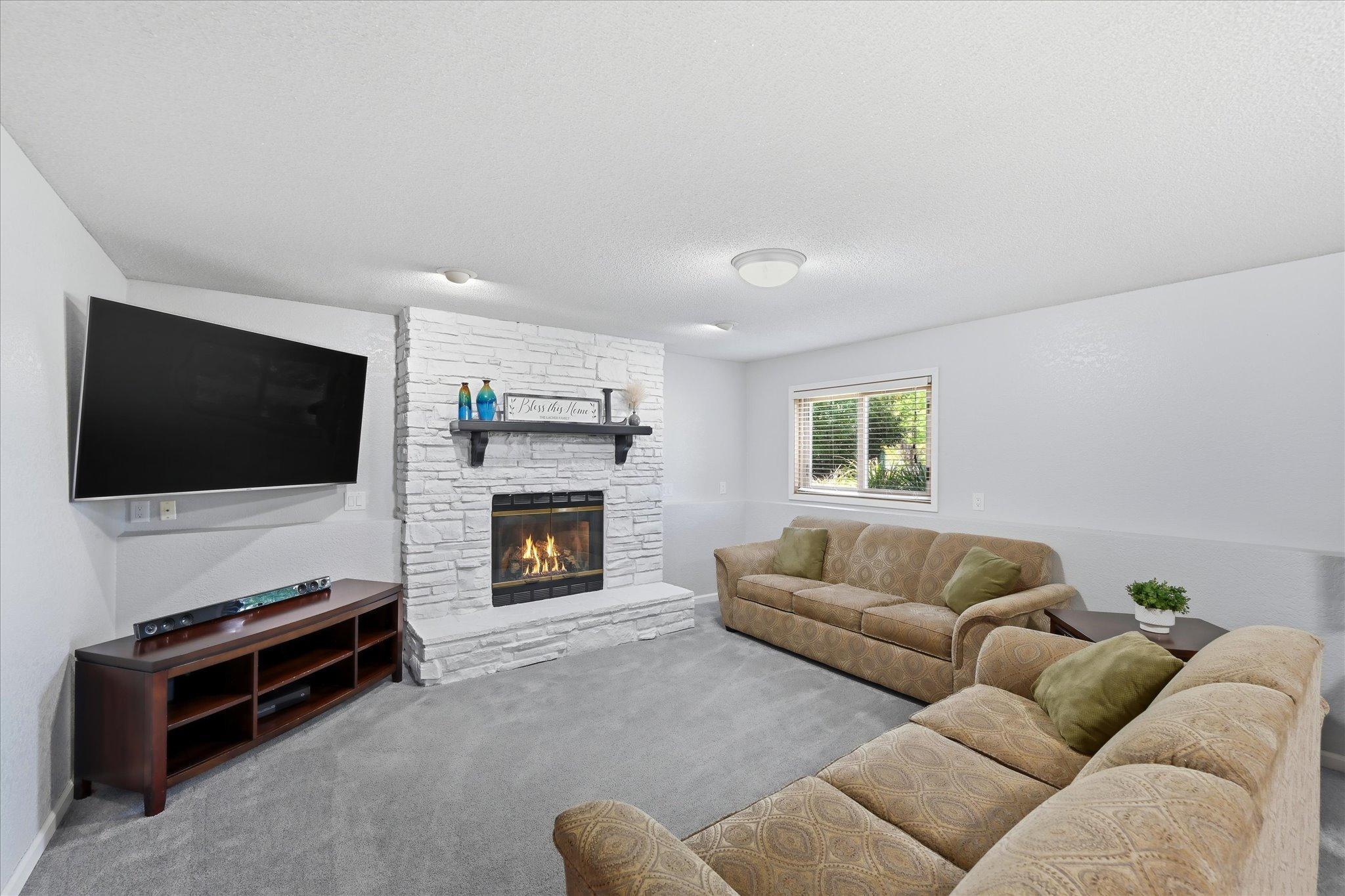 A cozy gathering space centered around the fireplace.