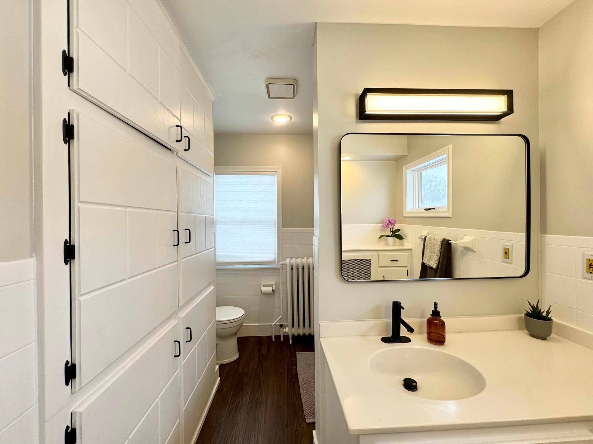 Bathroom has lots of storage.