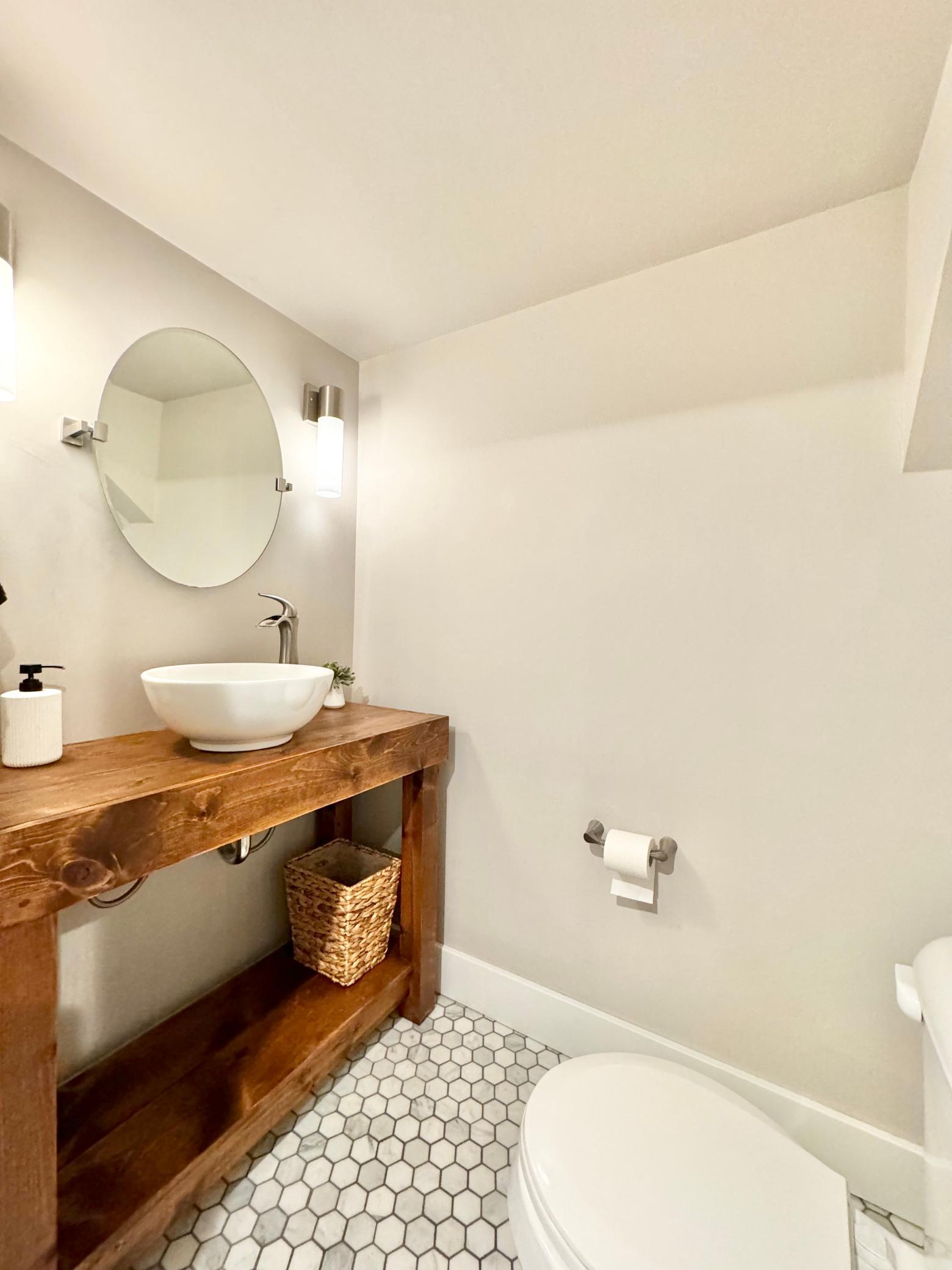 Lover level bathroom features marble flooring.