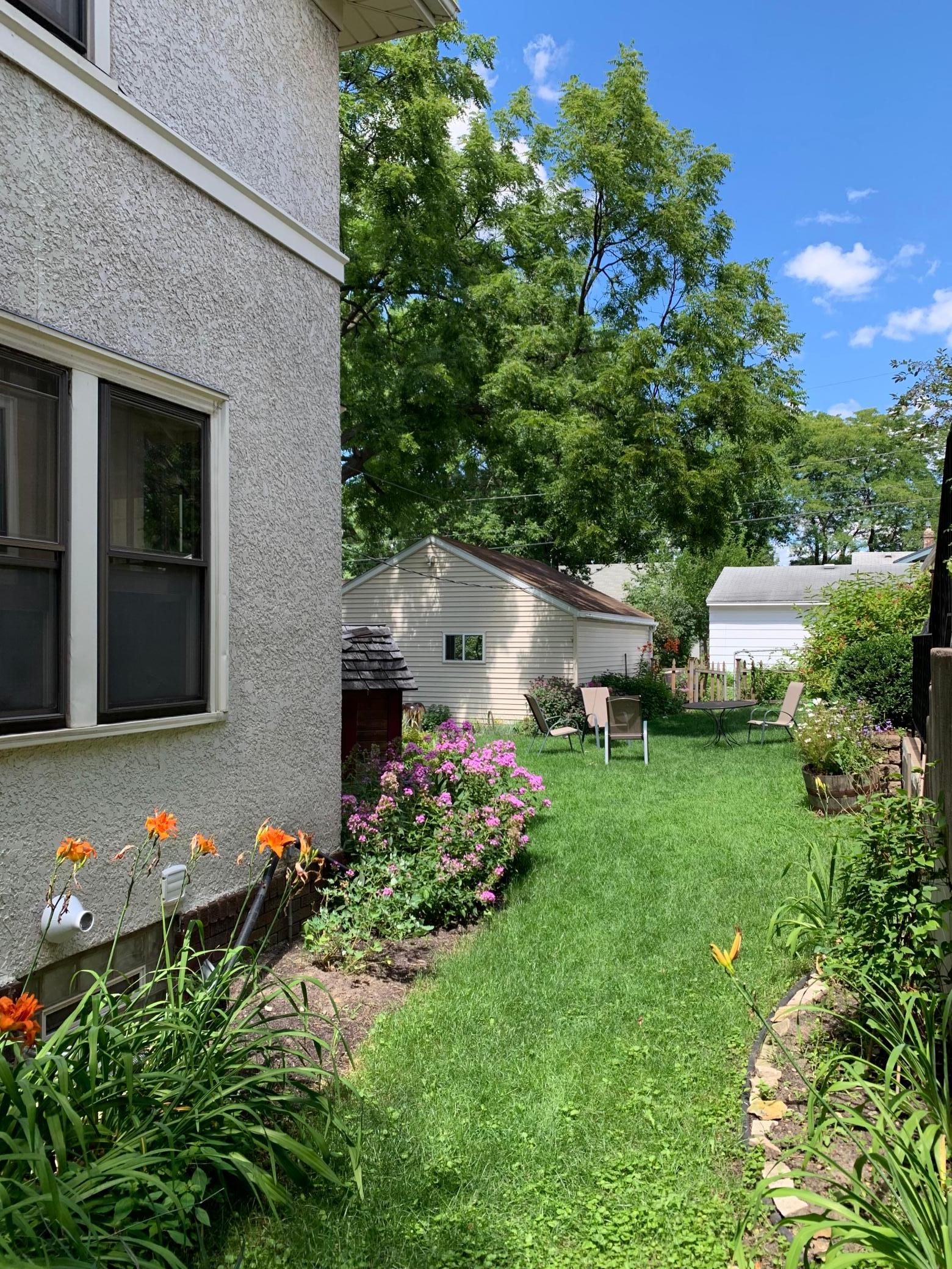 Yard view has lots of beautiful perennial plants.
