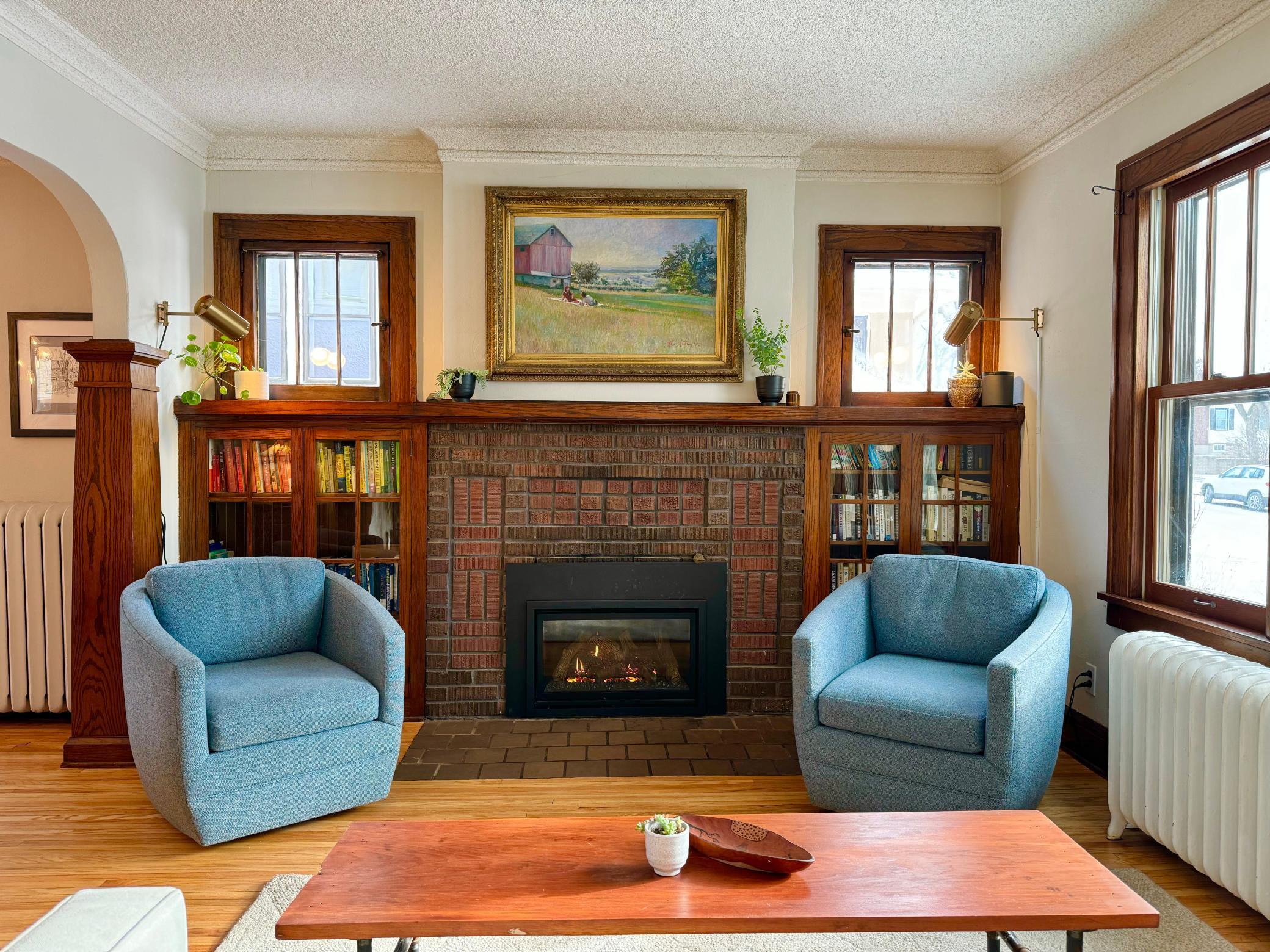 Cozy gas fireplace with brick surround and built-ins.