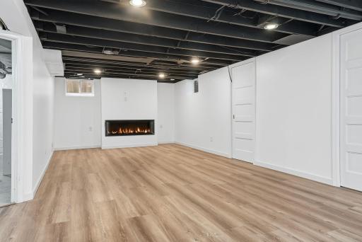 Huge basement finished family room with cozy electric fireplace!