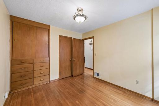 Main floor bedroom 2 with built in dresser/storage in addition to closet