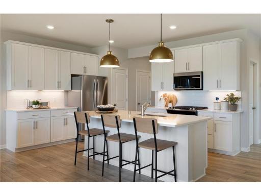 Model photos! Large Quartz center island with plenty of seating.