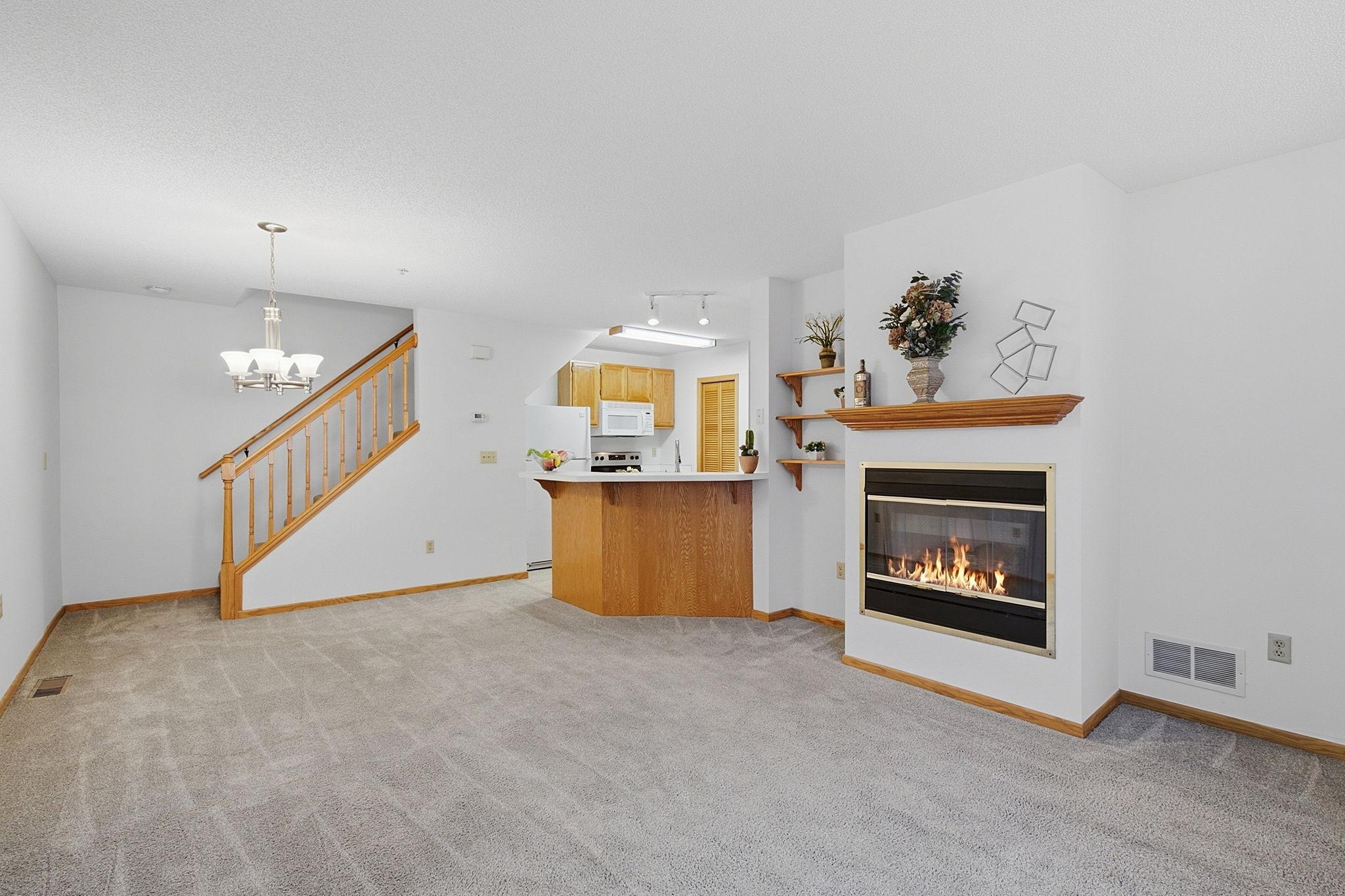 Open-concept living and dining area with a gas fire place.