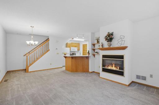 Open-concept living and dining area with a gas fire place.