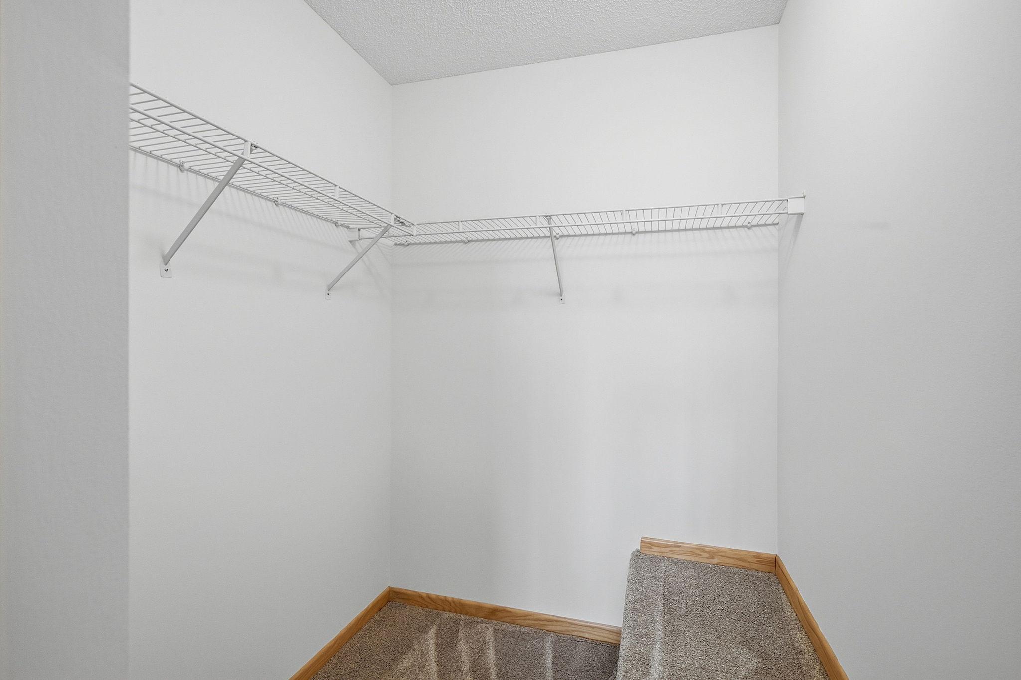 Walk-in closet in master bedroom.