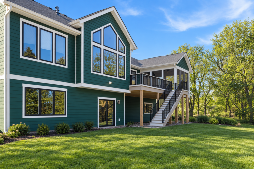 Modern Green House and Landscaped Yard.png