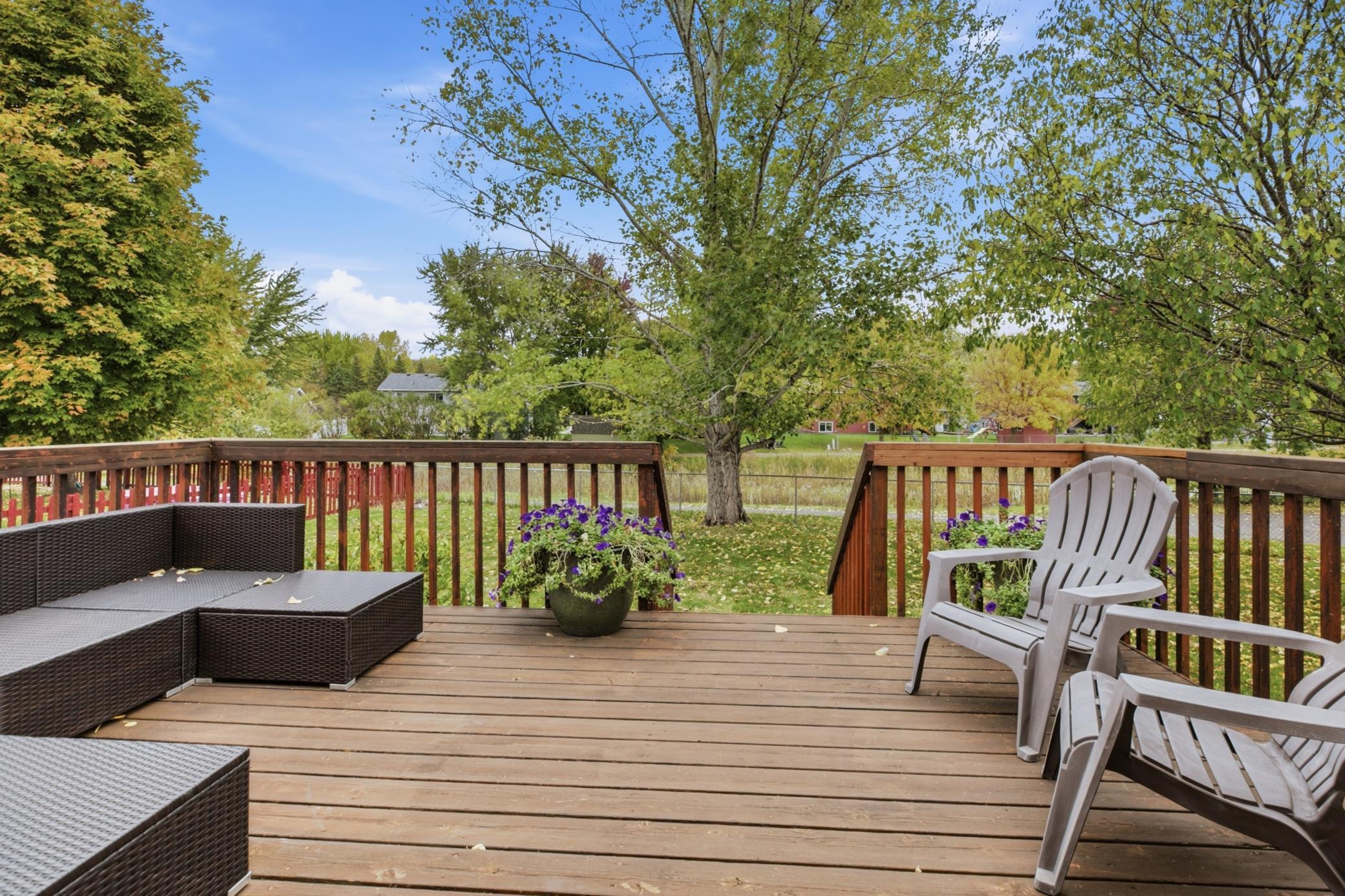 The deck was added in 2000, and the chain-link fence was installed in 2001, creating an established outdoor space for relaxing, entertaining, gardening, or enjoying time outdoors.