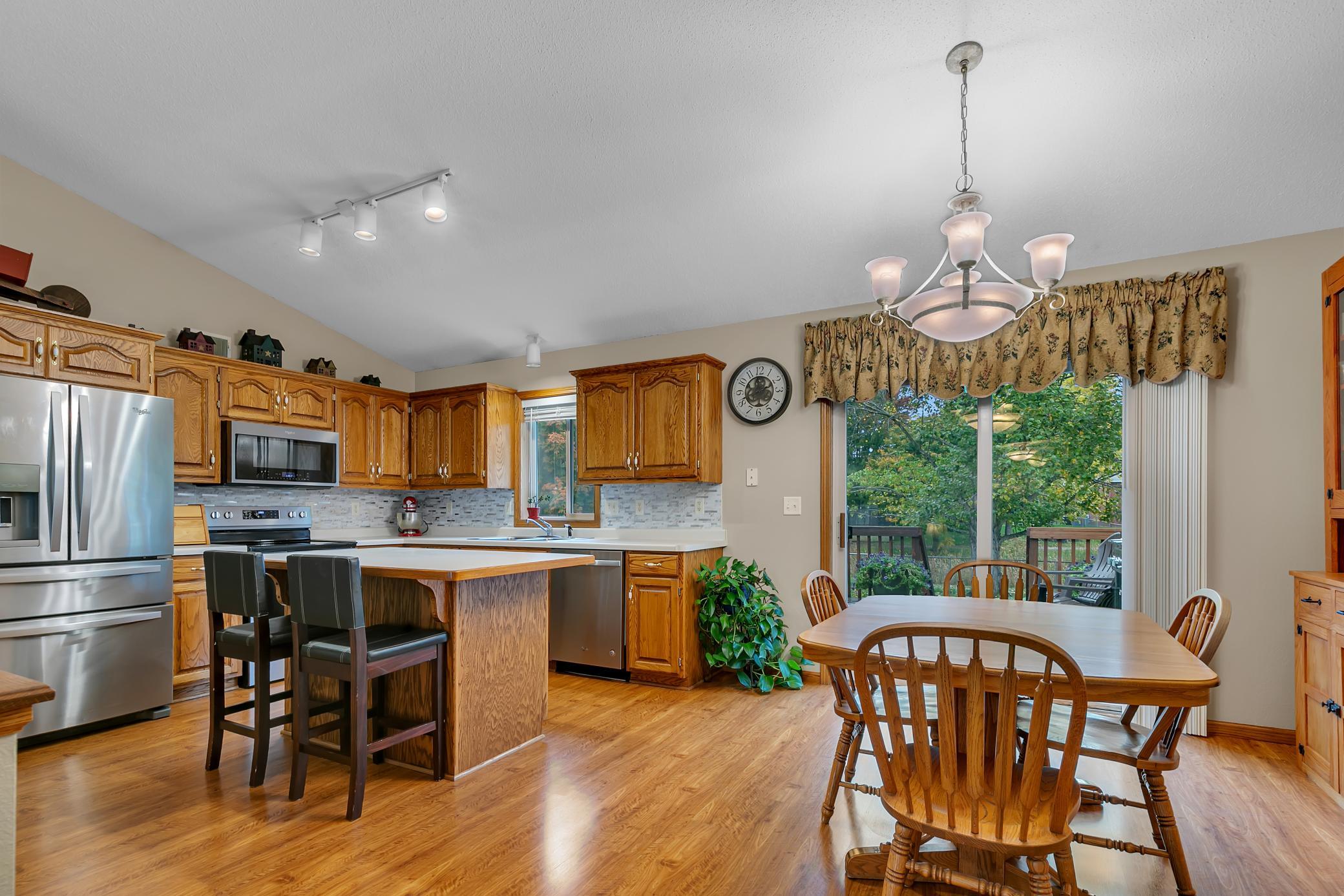 The kitchen also offers a functional island with additional counter space, drawers, cabinetry, and an electrical outlet.