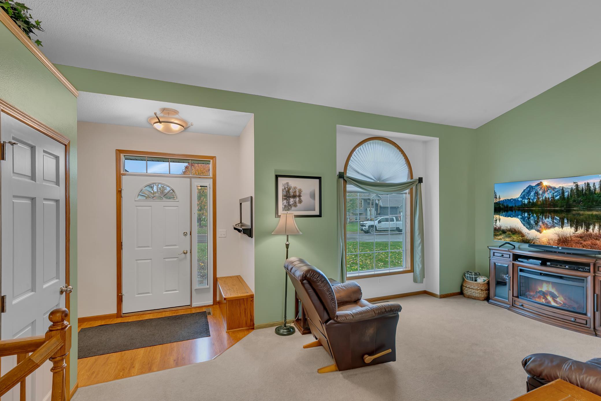 The foyer offers practical everyday convenience with a built-in sit-down bench featuring additional cubby storage.