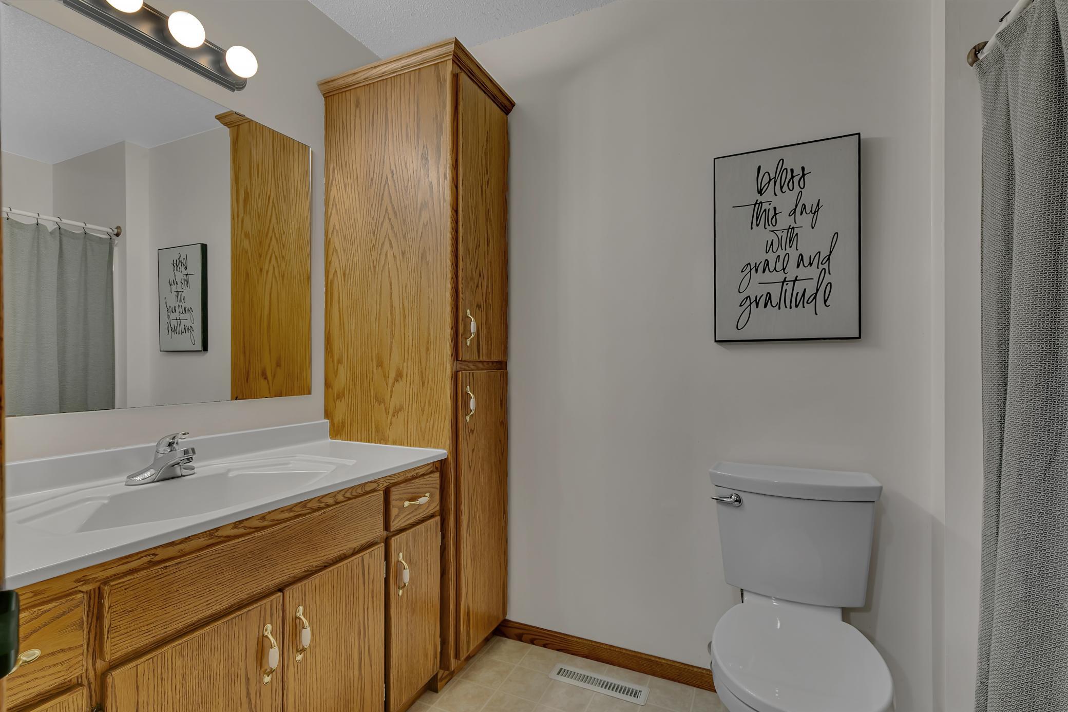 This full bathroom offers a spacious double linen cabinet beside the vanity. Both upstairs toilets have been replaced within the past 10 years, adding to the home's ongoing maintenance and care.