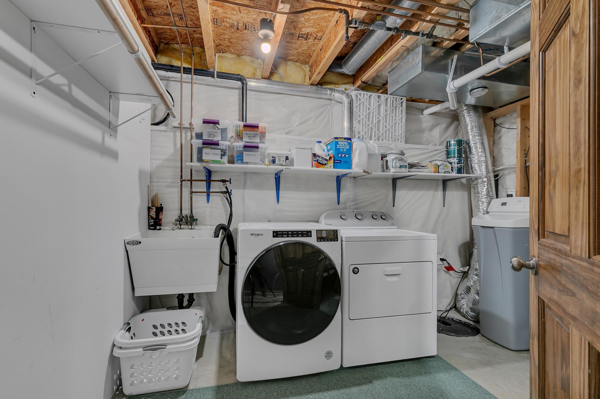 The home’s laundry area includes a front-load Whirlpool washer and dryer, both of which will remain with the property.