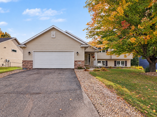 Four-level split at 420 NE 9th Ave in Lonsdale with covered front porch and attached 2-car garage.
