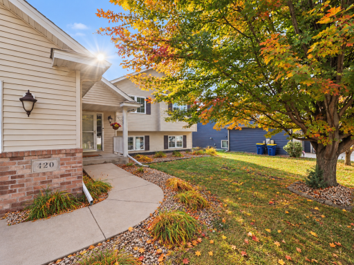 Curved front walk leading to the covered entry.