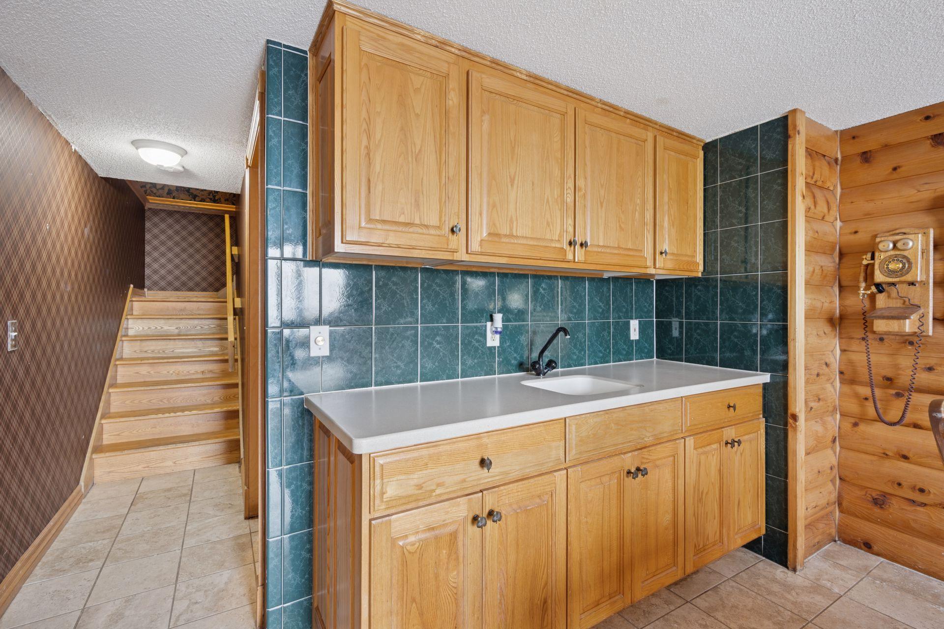 Dining Room Equipped with Sink and Cabinetry