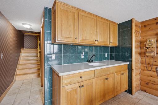 Dining Room Equipped with Sink and Cabinetry