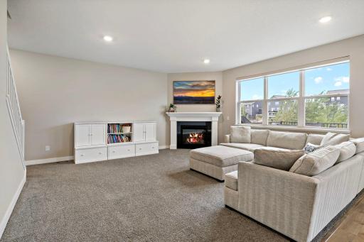 The spacious living room features a corner gas fireplace.