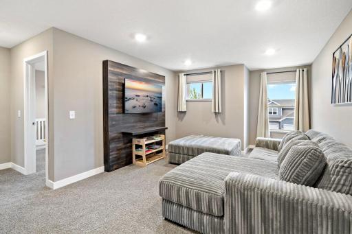 Spacious upper level loft area with built in storage, TV & mount included!