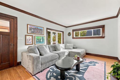 The front living room is bright and offers hardwood floors into the dining space.