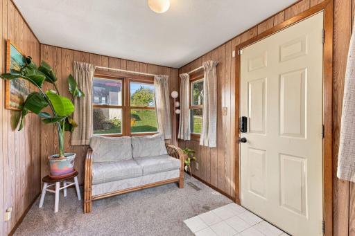 This home has the perfect front porch entrance. It's a great sitting space and it offers plenty of room for shoes and coats.