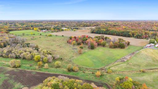 A diverse landscape of open meadows, scattered trees, and natural wooded areas provides a variety of possibilities for future land use