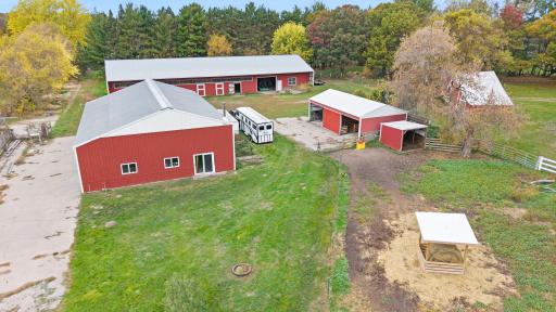 An overhead view of the property's collection of agricultural buildings, offering extensive space for horses, equipment, workshop use, and storage