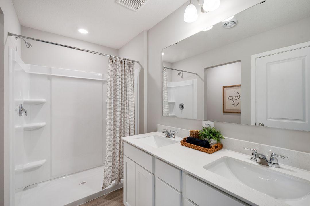 Dual vanities in the primary bathroom maximize convenience and reduce morning stress! Photo of model home. Colors and finishes may vary.