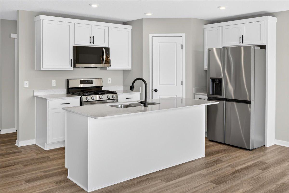 PHOTO OF A DIFFERENT HOME WITH SIMILAR PLAN AND FINISHES.