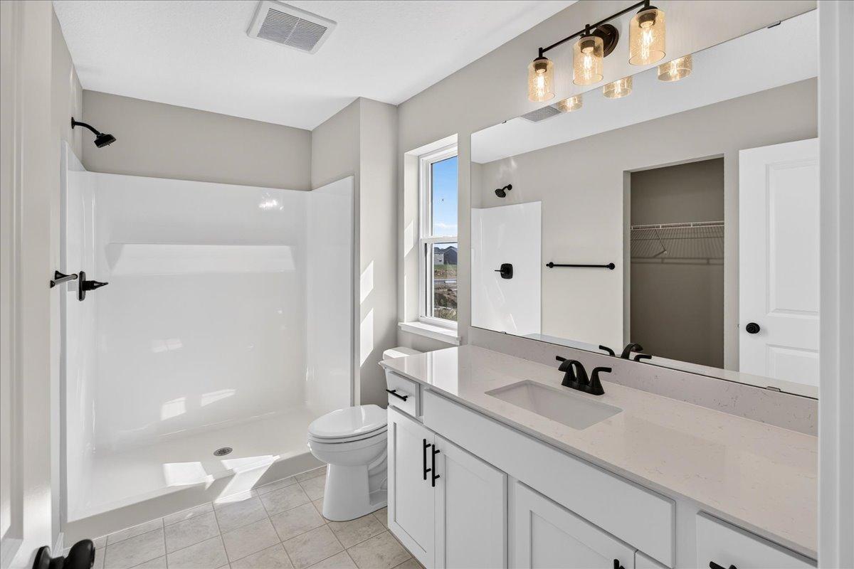 PHOTO OF A DIFFERENT HOME WITH SIMILAR PLAN AND FINISHES. Primary Suite Private Bathroom.