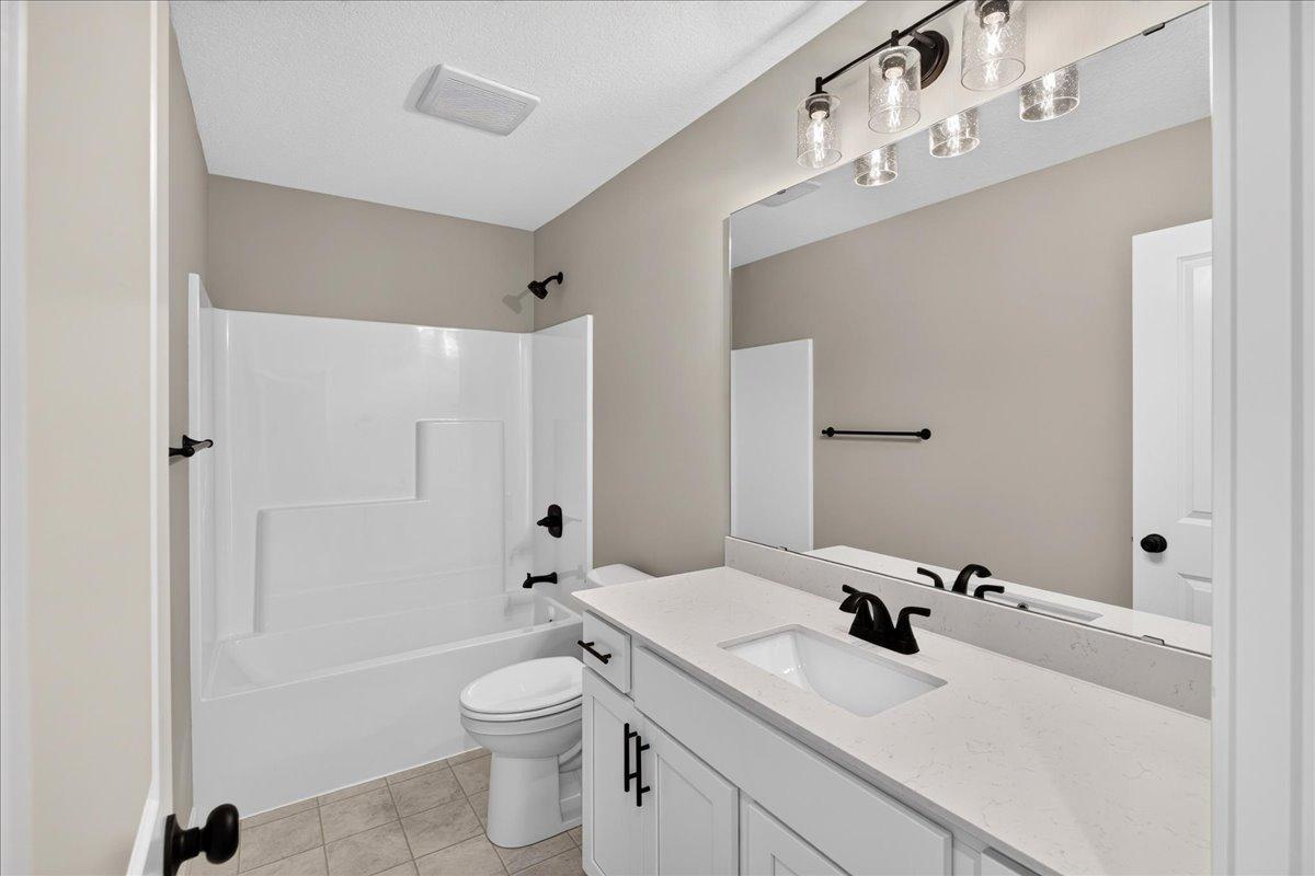 PHOTO OF A DIFFERENT HOME WITH SIMILAR PLAN AND FINISHES. Upper Main Bathroom.