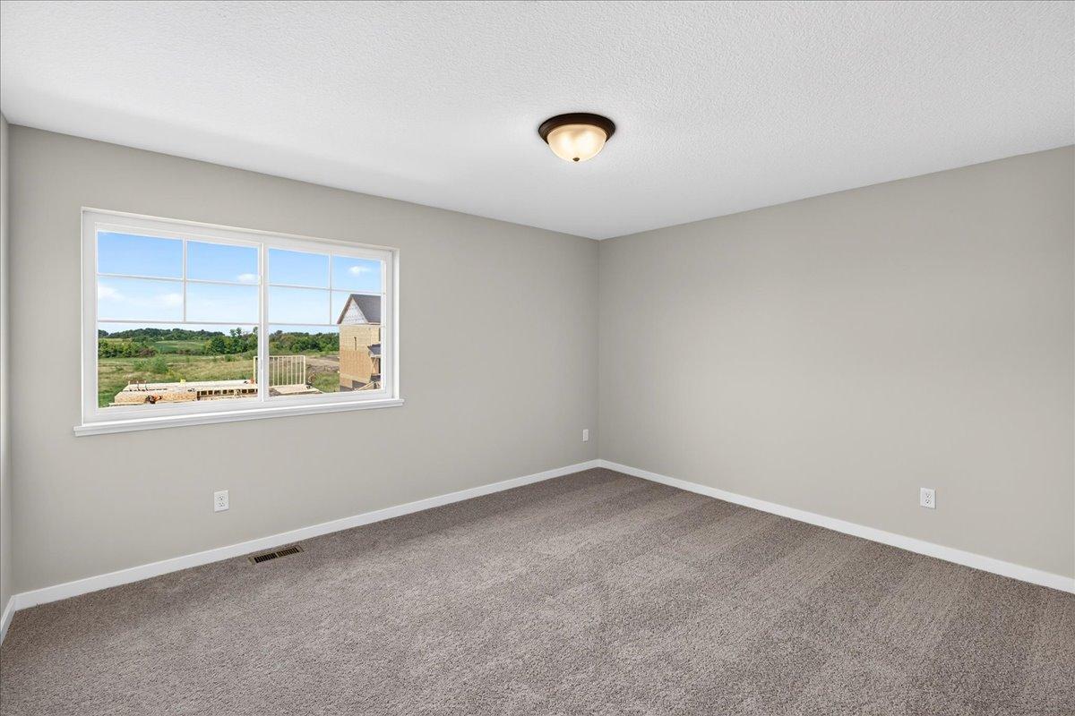 PHOTO OF A DIFFERENT HOME WITH SIMILAR PLAN AND FINISHES. Bedroom 3.