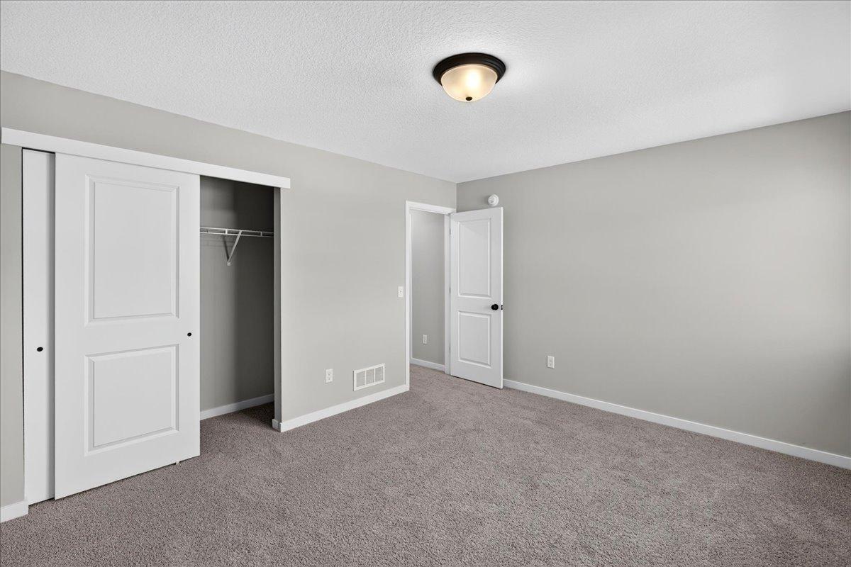 PHOTO OF A DIFFERENT HOME WITH SIMILAR PLAN AND FINISHES. Bedroom 3.