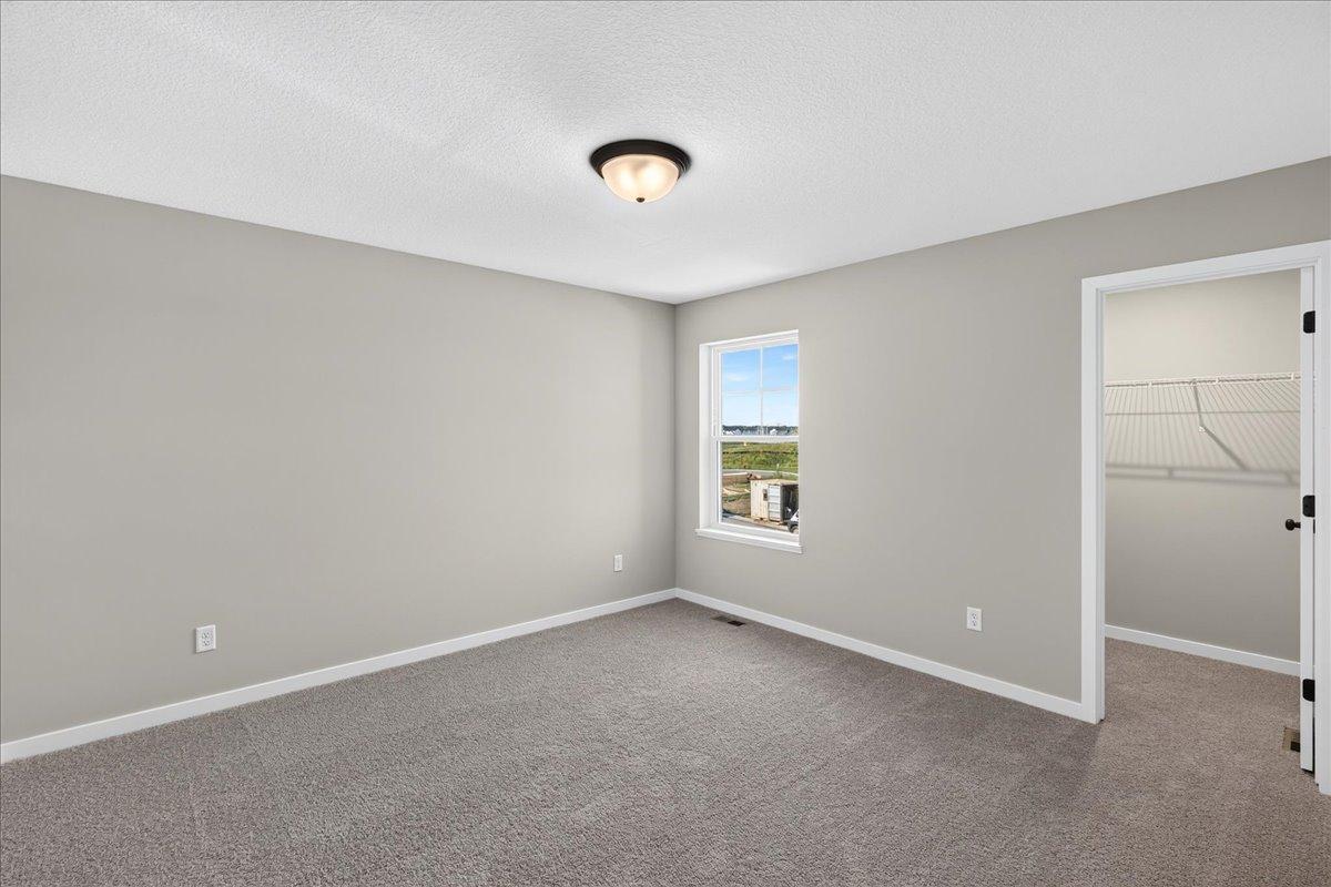 PHOTO OF A DIFFERENT HOME WITH SIMILAR PLAN AND FINISHES. Bedroom 2.
