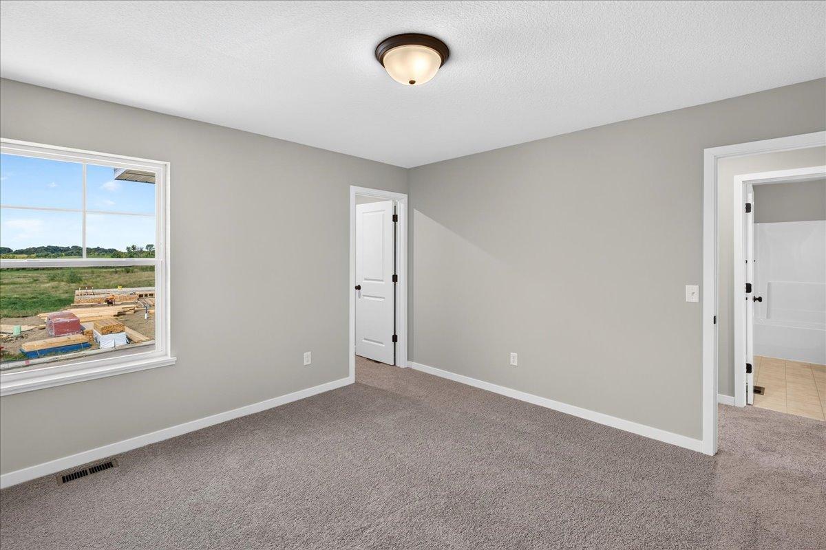 PHOTO OF A DIFFERENT HOME WITH SIMILAR PLAN AND FINISHES. Bedroom 2.