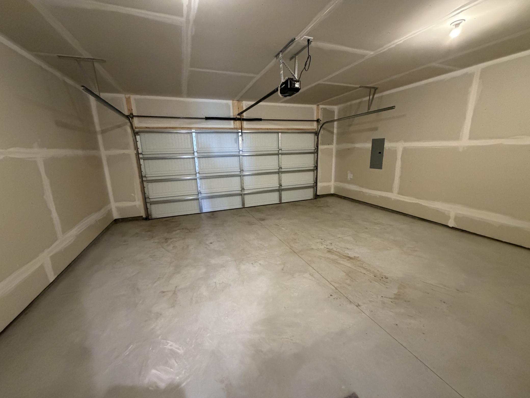 PHOTO OF A DIFFERENT HOME WITH SIMILAR PLAN AND FINISHES. Garage.