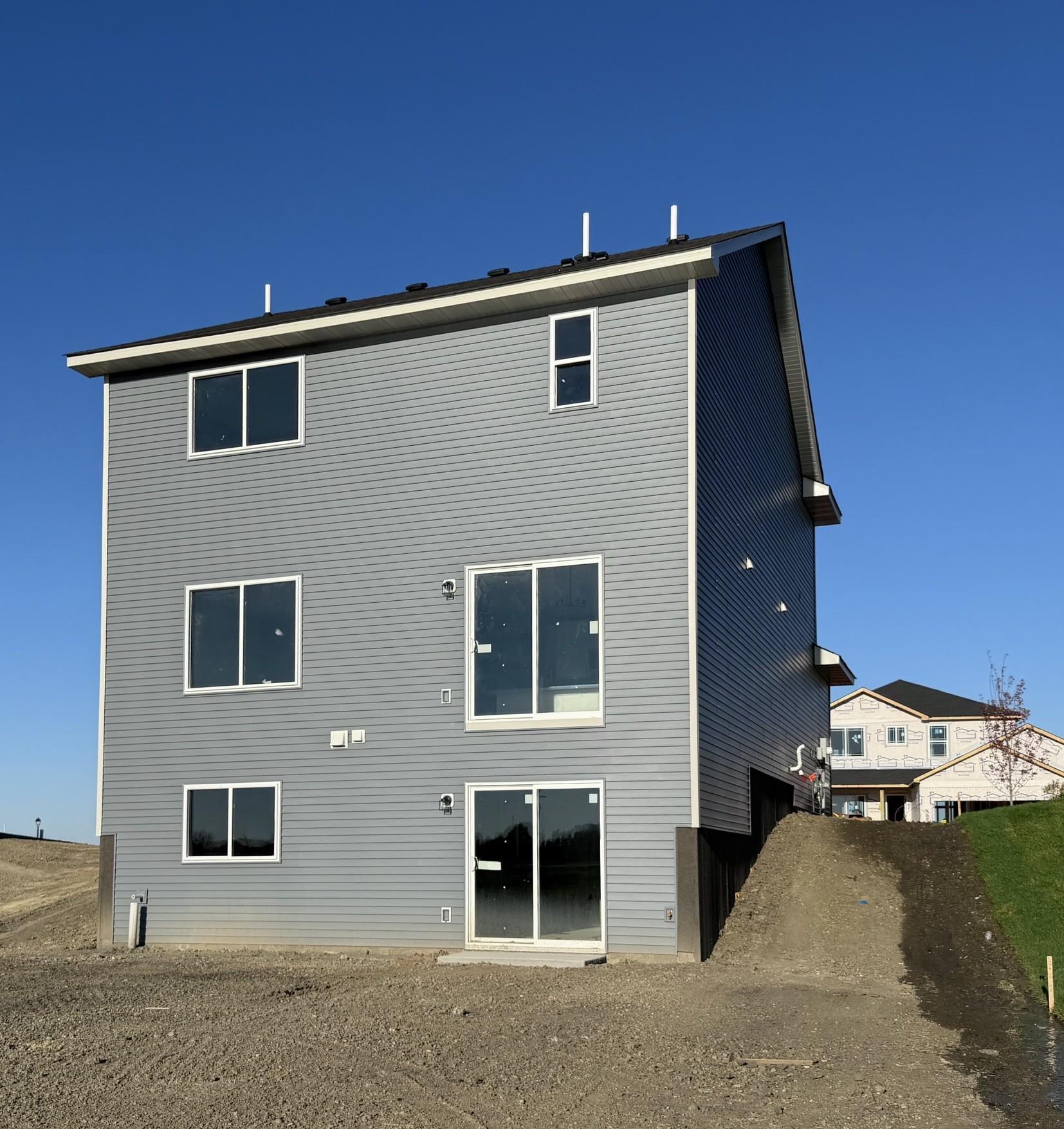 3050 Jandura Ave NE- Rear elevation features a Walkout Lower Level to spacious backyard!