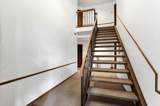 Interior common stairway leading to the upper-level unit, conveniently located at the top left.
